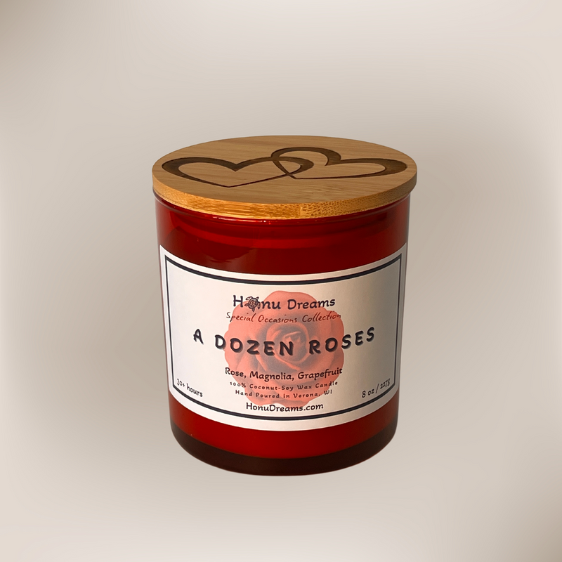 A red glass jar candle called A Dozen Roses